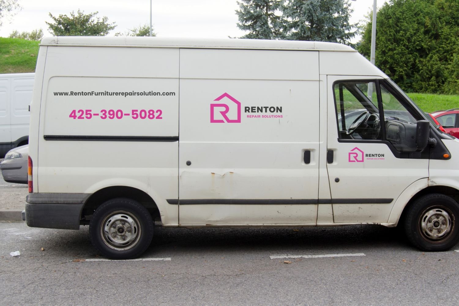 A white delivery van with "RENTON" in pink lettering and contact number 425-390-5082 on the side, parked on a street.